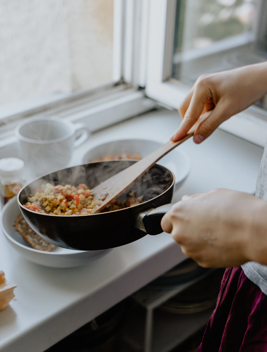 Mujer cocinando en una cocina luminosa